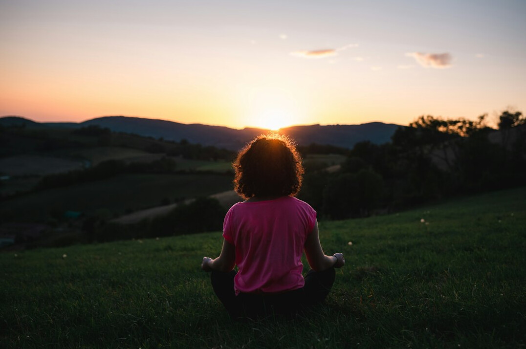 person meditating in morning light