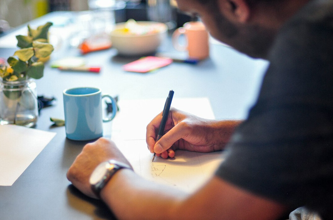 man writing notes confidently