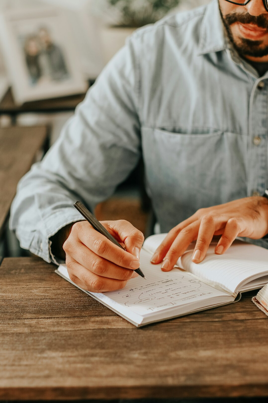person writing in journal